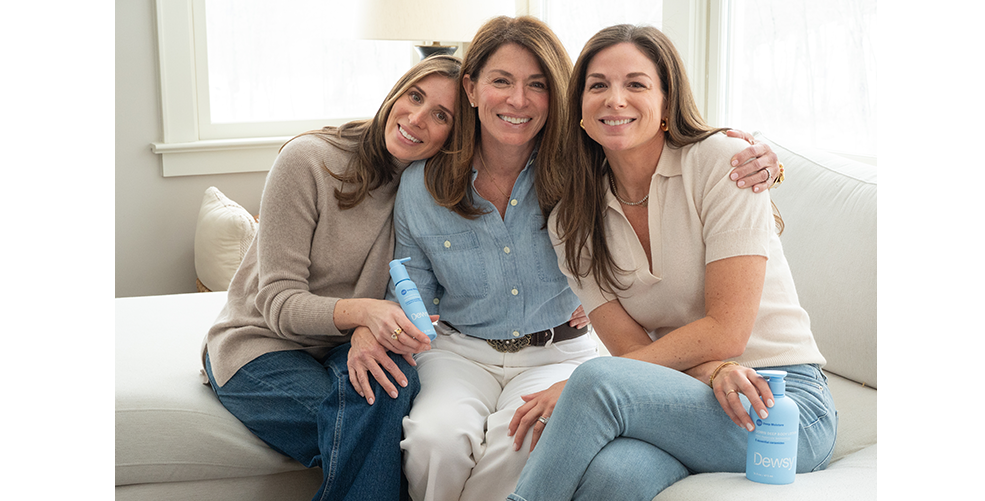 Dewsy founder Kathy sitting on a couch with two friends, smiling warmly — the inspiration behind Dewsy body care